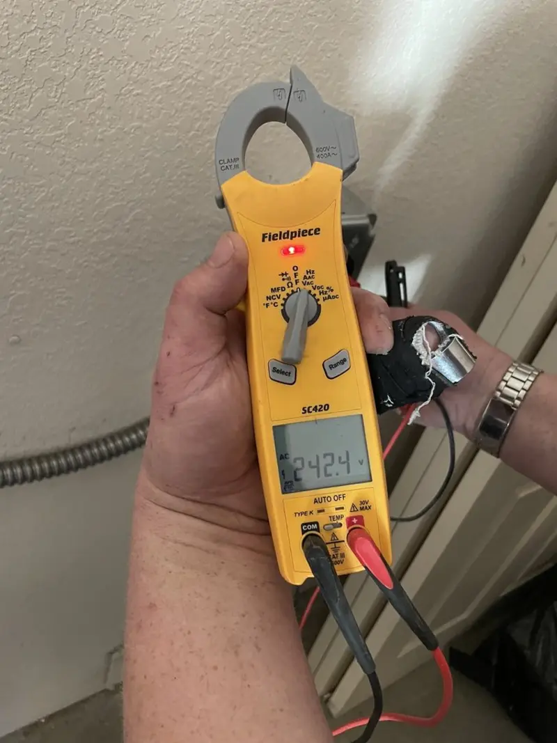 Voltage testing with clamp meter during Ceiling Fan Installation in Southington